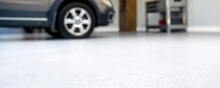 garage floor with tan car