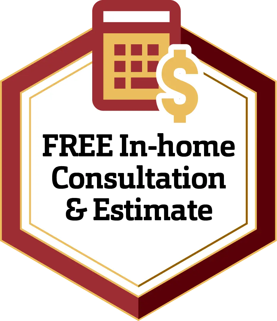 A hexagonal badge with a maroon border containing a calculator and a dollar sign icon at the top. The text inside reads, "FREE In-home Consultation & Estimate" in bold black letters on a white background.