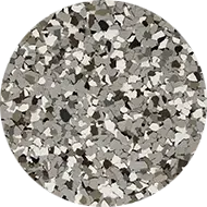 A circular arrangement of irregularly shaped, multicolored chips in shades of white, gray, and black, forming a textured, mosaic-like pattern.