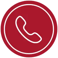 Icon of a white telephone handset inside a red circle with a white border, symbolizing the first steps toward franchise ownership.